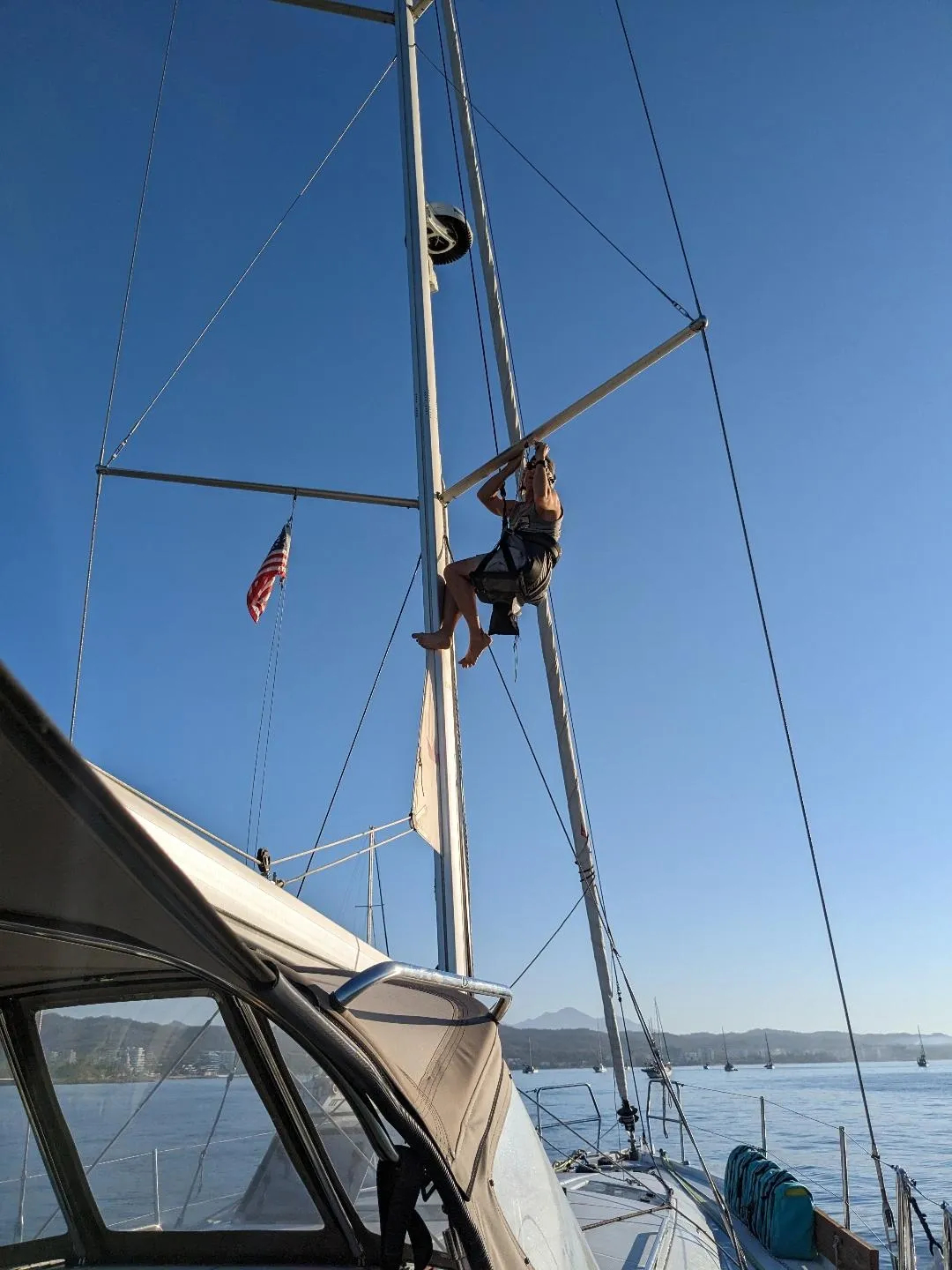 Bev hoisted Kevin up in the bosun chair to fix the flags on the starboard spreader