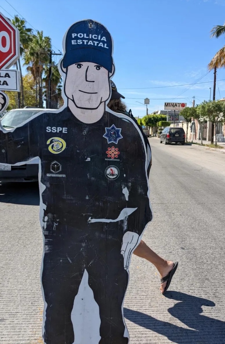 La Paz has cardboard cut out cops in the middle of some streets with an ALTO sign