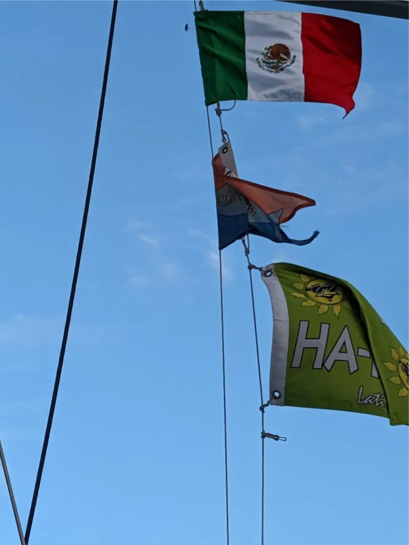 Flags on the signal halyard - Mexican flag, Coho Ho Ho and Baja Ha Ha flags