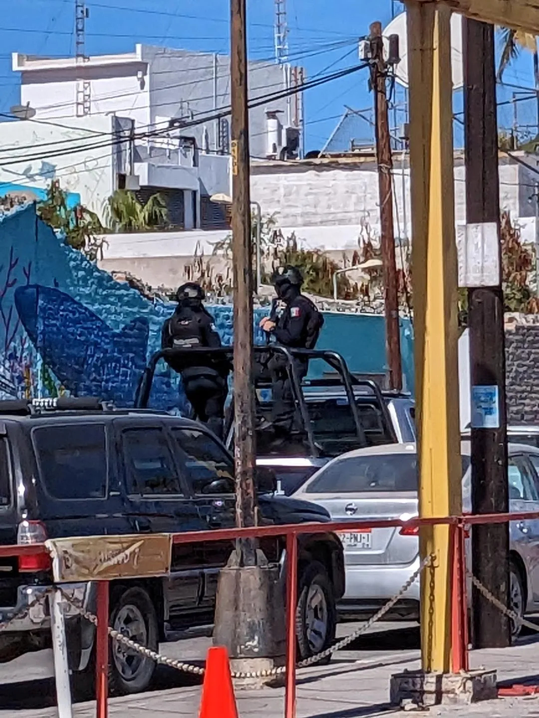 Armed military riding in back of trucks in the streets of La Paz