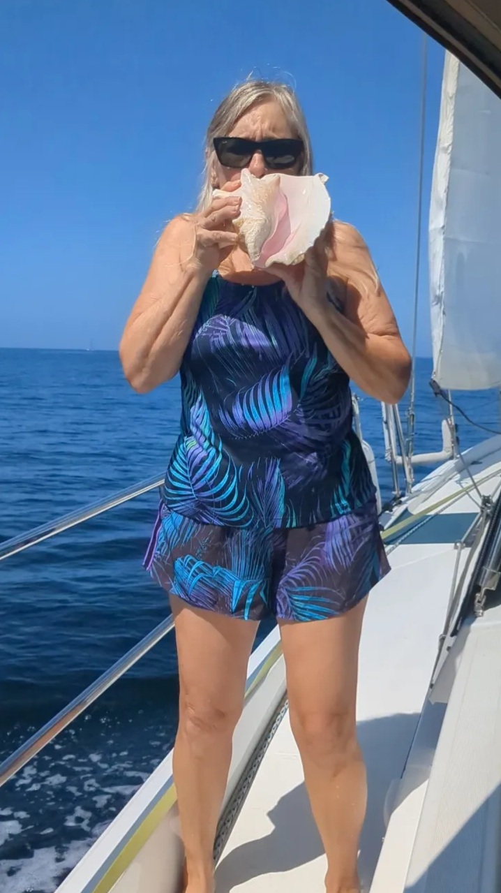 Bev blowing on a conch shell
